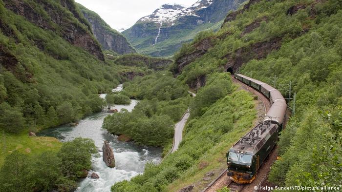 A train passes though a verdant valley